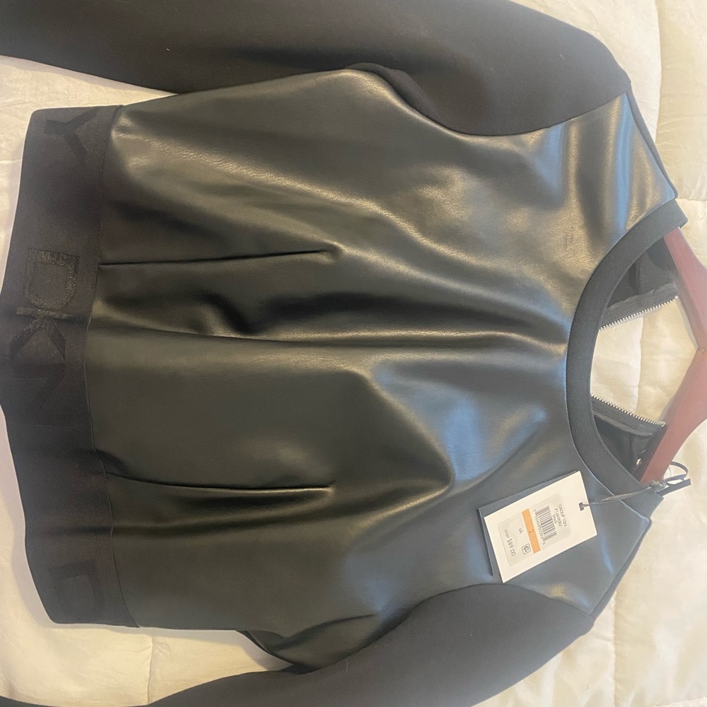 Long sleeve black blouse . Front it’s leather and nice stretch back.